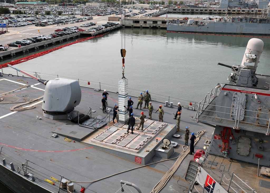 Reloading vertical missile tubes at sea is within a crane arm’s reach