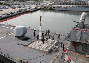 Reloading vertical missile tubes at sea is within a crane arm’s reach