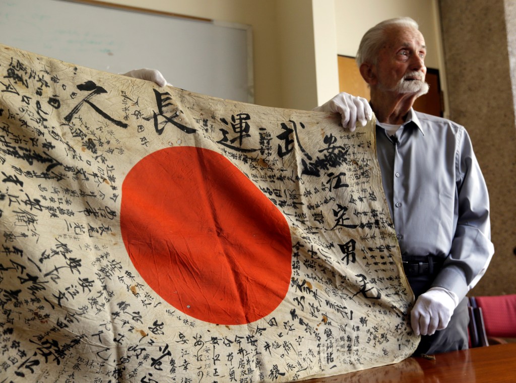 WWII veteran, 93, brings back flag taken from enemy soldier