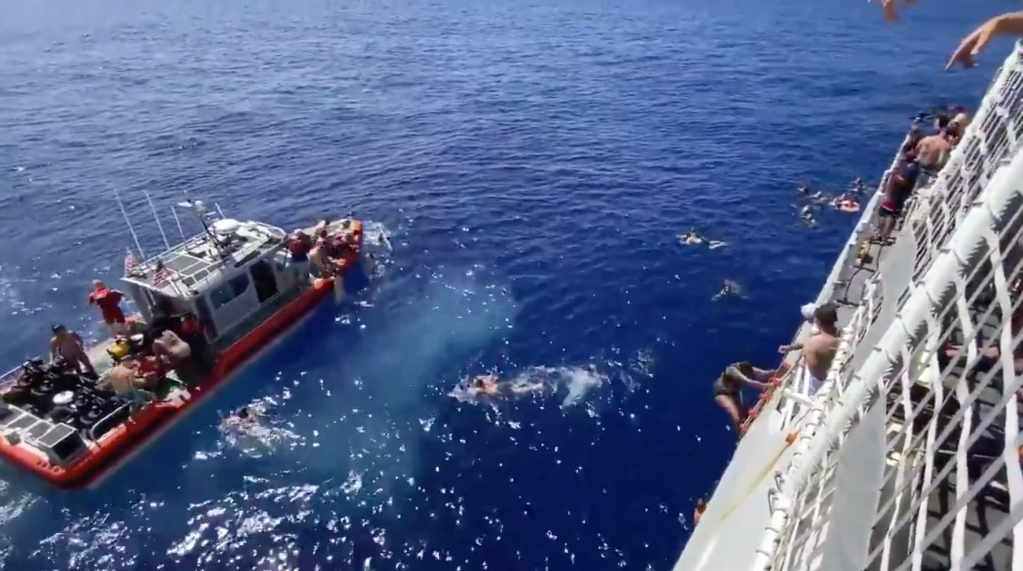Watch the Coast Guard shoot at a shark for trying to join a swim call party