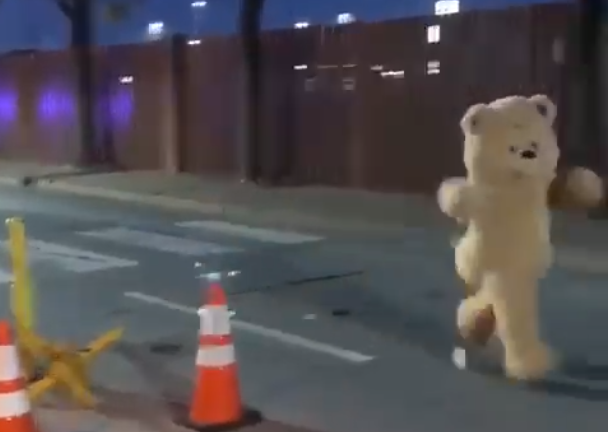 Giant dancing teddy bear risks it all during death-defying sprint onto military base