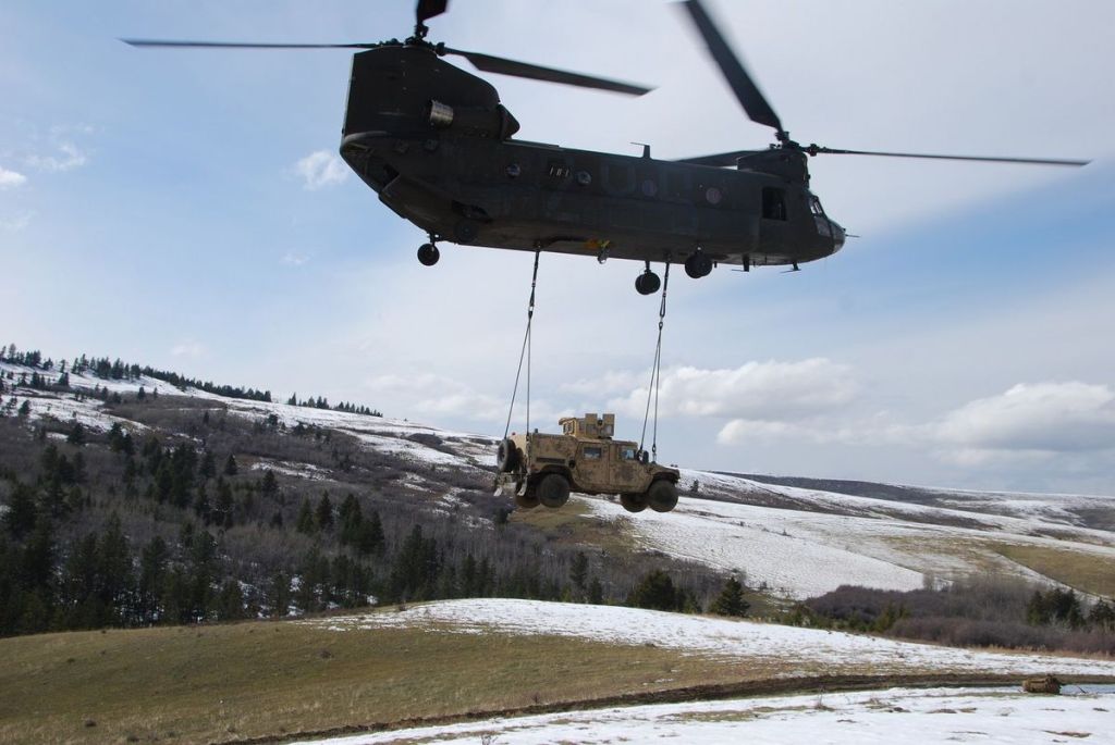 National Guard Chinook frees Air Force Humvee from muddy road