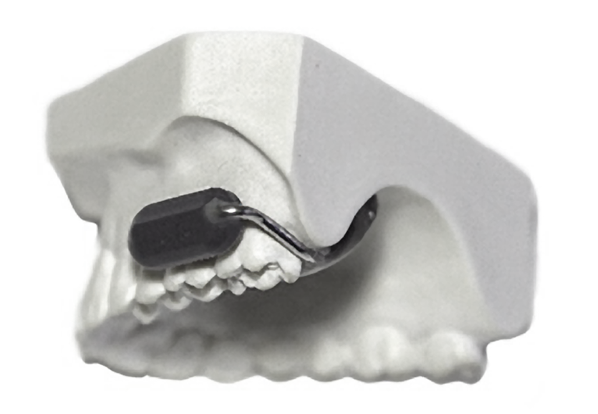 This new wireless communication device fits on your teeth